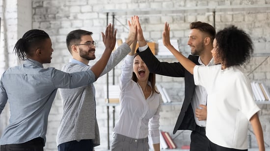 Coworkers high-five as they conquer record-breaking change in the mortgage industry
